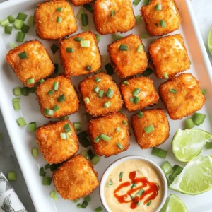 - 1 lb fresh salmon, skinless and cut into bite-sized cubes - 1 cup panko breadcrumbs - ½ cup all-purpose flour - 2 large eggs, beaten - ½ teaspoon garlic powder - ½ teaspoon paprika - Salt and pepper to taste - 1 cup mayonnaise - 3 tablespoons sweet chili sauce - 1 tablespoon sriracha (adjust to taste) - 1 teaspoon lime juice - Fresh green onions, chopped (for garnish) For this dish, I love using fresh salmon. It gives the bites a great taste and texture. Panko breadcrumbs provide the crunch, while the eggs help the coating stick. Flour helps the salmon to get a nice crust. The seasoning is simple but packs a punch. Garlic powder and paprika add depth. Salt and pepper balance everything out. The Bang Bang sauce is my favorite part. It’s creamy, spicy, and sweet. I use mayonnaise as a base. Sweet chili sauce brings sweetness, while sriracha gives heat. A splash of lime juice adds brightness. Don’t forget to garnish with green onions. They add color and freshness. You can find the full recipe at the top. Enjoy making these crispy bites! Set up your three shallow bowls. In the first bowl, add flour and season it with garlic powder, paprika, salt, and pepper. In the second bowl, place your beaten eggs. In the third bowl, pour in the panko breadcrumbs. This will make the breading process quick and easy. Now, take each salmon cube. First, dip it into the seasoned flour. Make sure it gets a good coat. Shake off any extra flour. Next, dip the salmon cube into the egg mixture. Let any excess egg drip off. Finally, roll the salmon in the panko breadcrumbs. Press gently so the crumbs stick well. Heat about half an inch of vegetable oil in a large skillet over medium-high heat. Wait until the oil shimmers. Carefully add the breaded salmon bites in batches. Don’t overcrowd the pan. Fry them for 2-3 minutes on each side until they turn golden brown and crispy. Use a slotted spoon to take them out and place them on a plate lined with paper towels. This will help drain any extra oil. Once cooked, you can enjoy these crispy bites with the bang bang sauce. You can find the full recipe for this dish included above. To get that perfect crispiness, it's vital to heat your oil properly. I recommend using a large skillet with about half an inch of vegetable oil. Heat it over medium-high heat until it shimmers. This means it’s hot enough for frying. If the oil is too cool, your salmon bites will absorb oil and turn soggy. Fry them in small batches. Overcrowding the pan can lower the oil temperature. Cook for two to three minutes on each side. You want them golden brown and crispy. The Bang Bang sauce is easy to modify. If you like it sweeter, add more sweet chili sauce. For extra heat, increase the amount of sriracha. I often add a splash of lime juice for a bright kick. Taste as you go to find the perfect balance for your palate. You can even swap the mayonnaise for Greek yogurt for a lighter version. This keeps the sauce creamy while changing the flavor profile. A well-presented dish brings joy to the table. After frying, arrange your crispy salmon bites on a serving platter. Garnish with chopped green onions for a fresh touch. They add color and flavor. Serve lime wedges on the side for an extra zing. Drizzle some Bang Bang sauce over the bites for a bold look. This will entice your guests and make the dish pop. For the full recipe, check the cooking instructions to enhance your serving style. {{image_2}} If you want to switch it up, consider using different proteins. Chicken or shrimp works well. For a vegetarian option, try cauliflower or tofu. Both options offer a nice texture and flavor. You can follow the same breading and frying steps. This way, everyone can enjoy the dish. You can change the taste by using different sauces. Instead of Bang Bang sauce, try a spicy aioli. You can also use teriyaki or garlic butter for a twist. Experiment with spices like cumin or chili powder for extra flavor. Each change offers a unique taste and keeps things fun. Pair your Crispy Bang Bang Salmon Bites with simple sides. Fresh salad or jasmine rice complements the dish nicely. You can also serve them with a cold drink, like iced green tea. A light beer or a refreshing lemonade works too. Enjoy each bite with a perfect pairing for a great meal. To keep your crispy salmon bites fresh, let them cool first. Place any leftovers in an airtight container. You can refrigerate them for up to three days. If you want to store them longer, freeze the salmon bites. Just make sure to wrap them well in plastic wrap and foil. This helps prevent freezer burn. When it's time to enjoy your leftovers, reheating is key to keeping them crispy. The best method is to use an oven. Preheat your oven to 375°F (190°C). Place the salmon bites on a baking sheet and heat for about 10-15 minutes. This way, they regain their crunchy texture. Avoid using a microwave, as it makes them soggy. Crispy Bang Bang Salmon Bites stay fresh for about three days in the fridge. If you freeze them, they can last up to three months. Just remember to label your containers with the date. This way, you know when to enjoy them at their best. Yes, you can bake the salmon bites. Preheat your oven to 425°F (220°C). Arrange the breaded salmon bites on a baking sheet lined with parchment paper. Spray them lightly with cooking oil for crispiness. Bake for about 12-15 minutes or until golden brown. This method gives you a lighter option while still keeping the bites tasty. Absolutely! You can make the Bang Bang sauce a day in advance. Store it in an airtight container in the fridge. This sauce stays fresh for up to three days. Just give it a quick stir before you serve. Making it ahead saves time and lets the flavors meld together. Crispy Bang Bang Salmon Bites pair well with many sides. Here are some ideas: - Steamed rice or jasmine rice - Crisp salad with a light dressing - Fresh veggies, like cucumber or carrots - Sweet potato fries for a fun twist These sides complement the flavors and add balance to your meal. To check if the salmon bites are done, look for these signs: - The exterior should be golden brown and crispy. - The inside should be opaque and flake easily with a fork. - Use a meat thermometer; the internal temperature should reach 145°F (63°C). These tips ensure you serve perfectly cooked salmon bites every time. You now have all the tools to make Crispy Bang Bang Salmon Bites. We covered the ingredients, step-by-step cooking, and ways to keep them crispy. You can adjust flavors, try variations, and present them beautifully. With the right tips, your dish will impress everyone. Enjoy your cooking and have fun with this tasty recipe!