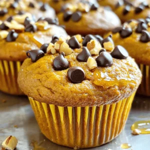 - 1 cup canned pumpkin puree - 3 ripe bananas, mashed - 3 large eggs - 1/2 cup almond butter (or any nut butter of choice) - 1/4 cup honey or maple syrup - 1 teaspoon vanilla extract - 1 teaspoon baking soda - 1 teaspoon ground cinnamon - 1/2 teaspoon ground nutmeg - 1/4 teaspoon salt - 1/2 cup dark chocolate chips (optional) How to choose ripe bananas Look for bananas that are yellow with small brown spots. They should feel soft but not mushy. This ripeness makes them sweeter and easier to mash. Best types of nut butter to use Almond butter is my favorite for this recipe, but you can use peanut butter or cashew butter. Just choose a nut butter without added sugar or oils for the best taste. Organic vs. conventional pumpkin puree I recommend using organic pumpkin puree when possible. It often has better flavor and fewer additives. Look for pumpkin that is 100% pure with no added ingredients. - Preheat your oven to 350°F (175°C). - Line a muffin tin with paper liners or grease it. - In a large bowl, combine the wet ingredients. - Use: - 1 cup canned pumpkin puree - 3 ripe bananas, mashed - 3 large eggs - 1/2 cup almond butter - 1/4 cup honey or maple syrup - 1 teaspoon vanilla extract - In another bowl, whisk together the dry ingredients. - Use: - 1 teaspoon baking soda - 1 teaspoon ground cinnamon - 1/2 teaspoon ground nutmeg - 1/4 teaspoon salt - Gently fold the dry mix into the wet mix. - Avoid overmixing to keep muffins fluffy. - If using chocolate chips, fold them in softly. - Fill each muffin cup about 3/4 full. - Bake for 18-20 minutes. - Check doneness with a toothpick; it should come out clean. - Cool muffins in the pan for 5 minutes, then move to a wire rack. Enjoy making these delicious flourless pumpkin muffins! For the complete recipe, check out the Full Recipe. To make the best flourless pumpkin muffins, use room-temperature ingredients. Cold eggs or nut butter can slow the mixing process. This can lead to uneven texture. Room-temperature items mix better, so take them out ahead. For a great rise, don't skip the baking soda. It helps the muffins puff up nicely. Make sure to mix the wet and dry ingredients gently. Overmixing can lead to dense muffins. One big mistake is overmixing the batter. This causes the muffins to be tough rather than light and fluffy. Mix just until you see no dry flour. Another common issue is baking time and temperature. Ovens can vary, so keep an eye on your muffins. Start checking for doneness at 18 minutes. Insert a toothpick in the center; it should come out clean. When serving your flourless pumpkin muffins, try them warm. A drizzle of honey on top adds a nice touch. You can also sprinkle crushed nuts or even dust with powdered sugar for fun. For a twist, add some dark chocolate chips for extra flavor. The rich chocolate pairs well with the pumpkin spice, making every bite a delight. Check out the Full Recipe for more details on making these tasty treats. {{image_2}} You can play with the flavors in these muffins. Adding spices like ginger or cloves can bring warmth and depth. Just a pinch can transform the taste. You can also mix in nuts or dried fruits. Chopped walnuts or pecans add crunch. Dried cranberries or raisins provide sweetness. Both options make your muffins special and unique. If you need nut-free options, you can use sunbutter or soy nut butter instead of almond butter. These swaps keep the muffins tasty and safe for those with nut allergies. For a vegan version, replace the eggs with flax eggs. Mix one tablespoon of ground flaxseed with three tablespoons of water for each egg. This simple swap works well in the recipe. The Full Recipe provides easy steps to follow. To keep your flourless pumpkin muffins fresh, store them in an airtight container. This helps lock in moisture. You can keep them at room temperature for up to three days. If you want them to last longer, consider refrigerating them. They can stay fresh in the fridge for about a week. For freezing, wrap each muffin in plastic wrap. Place them in a freezer-safe bag or container. They will keep well for up to three months. When you’re ready to enjoy them again, simply thaw them in the fridge overnight. Reheating muffins is easy. You can use a microwave for quick results. Heat them for 10 to 15 seconds. If you want a crispier texture, use an oven. Preheat your oven to 350°F (175°C), then place the muffins on a baking sheet. Heat them for about 5 to 10 minutes. To keep muffins moist while reheating, cover them with a damp paper towel in the microwave. This adds steam and helps maintain their softness. Are flourless pumpkin muffins gluten-free? Yes, flourless pumpkin muffins are gluten-free. They use pumpkin and bananas instead of flour. This makes them great for those who avoid gluten. You can enjoy these muffins without any worries. Can I use other fruit purees instead of pumpkin? Yes, you can use other fruit purees. Applesauce or mashed sweet potato works well. These options give a different taste but keep the muffins moist and tasty. What can I substitute for honey or maple syrup? You can use agave nectar or coconut sugar. Both options add sweetness without changing the texture. Just keep in mind they may alter the flavor a bit. Each muffin has about 100 calories. They contain healthy fats from nut butter and fiber from pumpkin and bananas. This keeps you full and satisfied. Here is the breakdown: - Calories: 100 - Protein: 3g - Fat: 5g - Carbohydrates: 12g - Fiber: 2g The ingredients have many health benefits. Pumpkin is high in vitamin A, which is good for your eyes. Bananas add potassium, which helps your heart. Almond butter gives you protein and healthy fats. This makes these muffins both tasty and good for you. How long do muffins last at room temperature? Flourless pumpkin muffins last about three days at room temperature. Keep them in an airtight container to keep them fresh. If you want them to last longer, consider freezing them. Signs of spoilage for baked goods Check for mold or an off smell. If the muffins feel dry or hard, they may be stale. Trust your senses. If something seems wrong, it's best to toss them. Enjoy your fresh muffins while they last! This blog post gave you all the tools to make flourless pumpkin muffins. We covered ingredients, from ripe bananas to nut butter choices. You now know how to mix and bake them perfectly. Avoid common mistakes and follow my tips for the best muffins. Explore variations to suit your taste and store them well for later. Remember, these muffins are easy, healthy, and versatile. Enjoy every bite and get creative with your own ideas!