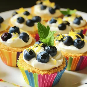 To make the 20-Minute Mini Lemon Blueberry Cheesecakes, gather these simple ingredients: - 1 cup graham cracker crumbs - 4 tablespoons unsalted butter, melted - 8 oz cream cheese, softened - 1/2 cup powdered sugar - 1 teaspoon vanilla extract - 1 tablespoon lemon juice - Zest of 1 lemon - 1 cup fresh blueberries - Optional: Fresh mint leaves for garnish Each ingredient plays a key role in creating the perfect balance of flavors. The graham cracker crumbs form a sweet and crunchy base. They pair perfectly with the creamy filling. The butter adds richness, helping the crust hold together. Cream cheese is the star of the cheesecake. It gives a rich and smooth texture. The powdered sugar sweetens the mix just right. Vanilla extract adds depth of flavor. Lemon juice and zest brighten everything up with a zesty kick. Fresh blueberries add a burst of sweetness and color. They contrast nicely with the tart lemon. The optional mint leaves can make your dessert look even prettier. They also add a fresh aroma. This ingredient list makes it easy for you to create a delightful dessert in just 20 minutes. For the full recipe, check out the details above! 1. Preheat your oven to 350°F (175°C). This ensures the crust bakes evenly. 2. Grab a medium bowl. Mix 1 cup of graham cracker crumbs with 4 tablespoons of melted butter. Stir until it looks like wet sand. 3. Line a muffin tin with cupcake liners. Press about 1 tablespoon of the crumb mixture into each liner. Make it firm and even. Bake for 5 minutes. Then, take them out and let them cool. 1. In a large bowl, beat 8 oz of softened cream cheese with an electric mixer. Mix until it is creamy and smooth, with no lumps. 2. Gradually add in 1/2 cup of powdered sugar. Keep mixing until it blends in well. 3. Add 1 teaspoon of vanilla extract, 1 tablespoon of lemon juice, and the zest of 1 lemon. Beat this mixture until it is fluffy. 4. Carefully fold in 1 cup of fresh blueberries. Be gentle so you don’t break them. 1. Spoon the creamy cheesecake filling over the cooled crusts in the muffin tin. Fill each liner nearly to the top. 2. Place the mini cheesecakes in the refrigerator. Let them chill for at least 10 minutes. This helps them set nicely. You can find the full recipe to explore more details and tips. Enjoy making these delightful mini lemon blueberry cheesecakes! To get the best texture for your mini lemon blueberry cheesecakes, start with softened cream cheese. Softening cream cheese makes it easier to blend. This helps you avoid lumps in your filling. Let it sit at room temperature for about 30 minutes before mixing. When folding in the blueberries, be gentle. Use a spatula to lift and turn the mixture. This way, the blueberries stay whole and vibrant. If you stir too hard, they can break apart. To make your cheesecakes look amazing, serve them chilled. Top each cheesecake with a few extra blueberries. Add a sprig of mint for a pop of color. This makes your dessert not just tasty but pretty too! For leftovers, store them in an airtight container. They stay fresh in the fridge for up to three days. If you want to keep them longer, you can freeze them. Just wrap each one in plastic wrap, then place them in a container. This keeps them safe from freezer burn. For the full recipe, check out [Full Recipe]. {{image_2}} You can have fun with these mini cheesecakes by changing the flavors. For instance, try using strawberries or raspberries instead of blueberries. Fresh strawberries add a sweet touch, while raspberries bring a tart flavor. Both fruits pair well with the creamy cheesecake base. Another great option is to swap lemon for lime. Lime gives a bright and zesty twist to the recipe. It offers a fresh taste that is perfect for summer. Just use the same amount of lime juice and zest as you would lemon. Your guests will love this fun and tasty change. If you need a gluten-free option for the crust, use gluten-free graham crackers. They work just as well, and you can enjoy the same great taste without any gluten. Simply crush them as you would with regular graham crackers. For a healthier choice, consider using sugar alternatives. Products like erythritol or stevia can replace powdered sugar. This keeps sweetness but cuts down on calories. Just be sure to use the right amount, as these substitutes can vary in sweetness. You can now enjoy these mini cheesecakes while sticking to your dietary needs. To keep your mini lemon blueberry cheesecakes fresh, proper storage is key. - Refrigeration: Place the cheesecakes in an airtight container. This helps maintain their creamy texture. Store them in the fridge for up to five days. Just make sure they are fully chilled before sealing. - Freezing: If you want to save some for later, freezing works well. Wrap each cheesecake in plastic wrap, then put them in a freezer-safe bag. They can last up to three months frozen. When ready to eat, thaw them in the fridge overnight. How long do these mini cheesecakes last in the fridge? If stored correctly, they stay fresh for about five days. Watch for signs of spoilage. If you see any mold, or the cheesecake smells off, it's best to toss them. Always trust your senses! Fresh cheesecakes should smell sweet and tangy, not sour. For the full recipe, check out the section above. Yes, you can make these cheesecakes ahead of time. Prepare them a day before serving. Just keep them in the fridge. This gives the flavors time to blend well. If you want to prepare the crust early, you can do that too. Just store it in an airtight container until you're ready to use it. This way, you save time on the day of your event. The mini cheesecakes need at least 10 minutes in the fridge to set. For the best results, I suggest chilling them for about 30 minutes. This extra time helps them firm up nicely. A longer chill also improves the taste. Serve them cold for that perfect bite! Yes, you can easily double or halve this recipe. If you double it, use a larger muffin tin or bake in batches. Halving the recipe is also simple. Just divide the ingredients by two. This way, you can adjust to your needs without losing flavor. Use the Full Recipe as a guide for any changes. These mini cheesecakes are a fun and tasty treat. You learned about the key ingredients, the step-by-step process, and helpful tips. You can customize them with different fruits or adjust for dietary needs. Remember to store them properly for the best taste and freshness. These cheesecakes are simple to make and sure to please everyone. Enjoy your delicious creation, and don’t be afraid to get creative with flavors!