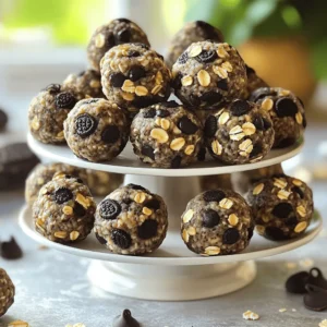 - 1 cup rolled oats - 1/2 cup vanilla protein powder - 1/2 cup almond butter (or peanut butter) - 1/4 cup honey or maple syrup - 1/4 cup crushed Oreo cookies - 2 tablespoons unsweetened cocoa powder - 1/4 cup dark chocolate chips (optional) - A pinch of salt To make Oreo protein balls, gather these ingredients first. Each one plays a key role in flavor and texture. The rolled oats provide a hearty base, while protein powder boosts nutrition. Almond butter or peanut butter adds creaminess and healthy fat. Honey or maple syrup gives sweetness. Crushed Oreo cookies add that classic taste. Cocoa powder enhances the chocolate flavor. Dark chocolate chips are optional but delicious. A pinch of salt balances everything nicely. - Calories per serving: About 100 calories per ball. - Protein content per ball: Around 5 grams of protein. - Other nutritional benefits: These protein balls are a good source of fiber and healthy fats. They can fuel your day, especially after workouts. The mix of oats and protein keeps you full longer. Plus, they taste great! For the Full Recipe, check out the detailed steps to create these tasty snacks. Mixing dry ingredients First, grab a large bowl. Add 1 cup of rolled oats, 1/2 cup of vanilla protein powder, 1/4 cup of crushed Oreo cookies, 2 tablespoons of cocoa powder, and a pinch of salt. Use a spoon to mix these ingredients. Make sure they blend well together. This step helps the flavors mix before adding wet ingredients. Combining wet ingredients In another bowl, take 1/2 cup of almond butter and 1/4 cup of honey (or maple syrup). Stir them together until they form a smooth mix. This mixture adds creaminess and sweetness to your protein balls. Forming the protein balls Now, pour the wet mix into the dry mix. Stir until the two come together. If the mix feels too dry, add a bit more almond butter or honey. Use your hands to scoop out about a tablespoon of the mix. Roll it into a ball. Place each ball on a parchment-lined baking sheet. Keep going until you roll all the mixture into balls. Time required to firm up Once you finish rolling the balls, pop them in the fridge for about 30 minutes. This time helps them firm up nicely. Tips for achieving the right texture If you want a softer ball, chill them for less time. For a firmer texture, let them sit a bit longer. Make sure to store them in an airtight container after chilling. You can find the Full Recipe for more detailed steps. To make your Oreo protein balls just right, you can change the sweetness and texture. If you want them sweeter, add more honey or maple syrup. For a firmer ball, add a bit more protein powder. If it feels too dry, just mix in a touch more nut butter. You can also use different nut butters. Almond butter gives a mild flavor. Peanut butter offers a richer, nuttier taste. You could even try cashew butter for a creamy twist. Each choice will change the taste, so feel free to experiment! Serving these protein balls can be fun and creative. You can stack them in a clear jar for a cute display. A tiered dessert stand looks great for parties. For easy snacking, pack them in an airtight container. These protein balls pair well with fresh fruits. Try serving them with berries or banana slices. They also taste great alongside smoothies, making for a tasty snack combo. For the full recipe, check the Full Recipe section. {{image_2}} You can easily change the flavor of your Oreo protein balls. Add nuts like almonds or walnuts for a nice crunch. Seeds, such as chia or flax, can boost nutrition. You can also switch up the protein powder. Try chocolate, cookies and cream, or even peanut butter flavors. Each one gives a new twist to the taste. You can make Oreo protein balls vegan or gluten-free. Use almond butter or sunflower seed butter instead of regular butter. For sweeteners, choose maple syrup or agave nectar to keep it vegan. To make them gluten-free, use certified gluten-free oats. You can also lower the sugar by using sugar-free syrup or a low-carb sweetener. This way, you can enjoy your snack while sticking to your diet. To keep your Oreo protein balls fresh, use an airtight container. Glass jars or plastic containers both work well. If you want to take them on the go, small snack bags are great too. For short-term storage, you can leave them at room temperature for a day. However, I suggest keeping them in the fridge for the best taste and texture. This helps them stay firm and tasty. In the fridge, your Oreo protein balls will last about one week. Just remember to check for any signs of spoilage. If you want to keep them longer, freezing is a smart choice. They can stay good in the freezer for up to three months. Just make sure to wrap them well in plastic and then place them in a freezer bag. When you want to eat them, just let them thaw in the fridge overnight. Enjoy your healthy snack anytime! Oreo protein balls last about one week in the fridge. Store them in an airtight container. If you freeze them, they can last up to three months. Just remember to thaw them in the fridge before eating. This way, they stay fresh and tasty for your snack time. Yes, you can replace the protein powder. Use any flavor you like, such as chocolate or cookies and cream. If you want a vegan option, try a plant-based protein powder. Just keep in mind that changing the flavor might change the taste of your protein balls. Experimenting can lead to fun new flavors! Oreo protein balls have some healthy benefits. They provide protein from the protein powder and nut butter. The oats give you fiber, which is good for digestion. However, they also contain sugar from honey and Oreos. Enjoy them as a treat, but don't forget about balance in your diet. Oreo protein balls are simple and fun to make. We listed ingredients and shared detailed steps. You learned about storage tips and variations to keep it interesting. Nutritional details help you know their health benefits. In the end, these protein balls are a tasty treat. You can enjoy them guilt-free. Experiment with flavors and share them with friends. Have fun creating your own versions!