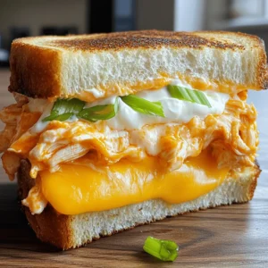 - 2 slices thick-cut bread (recommended: sourdough or ciabatta) - 1 cup cooked shredded chicken - 1/4 cup buffalo sauce - 1 cup shredded sharp cheddar cheese - 1/4 cup softened cream cheese - 2 tablespoons butter - Optional: 1/4 cup blue cheese crumbles - Optional: sliced green onions for garnish You need thick-cut bread to hold all the tasty layers. Sourdough or ciabatta works best. You want a good crunch when you bite in. Next, cooked shredded chicken brings the heartiness. Mix this with buffalo sauce for that spicy kick. You can adjust the buffalo sauce to your taste. Sharp cheddar cheese adds a rich flavor and melts perfectly. Cream cheese gives a creamy texture. It balances the heat from the buffalo sauce. Butter is crucial for that golden crust. If you like blue cheese, add it for extra flavor. Sliced green onions make a great garnish. They add a fresh touch and color. For the full recipe, follow the instructions carefully to create this mouthwatering sandwich! 1. Combine shredded chicken with buffalo sauce: Start by taking your cooked chicken and shredding it into small pieces. In a bowl, mix the shredded chicken with buffalo sauce. Stir well until each piece is coated. You can adjust the amount of sauce based on your taste. If you like it spicier, feel free to add more! 2. Mix cream cheese with shredded cheddar: In a separate bowl, add the softened cream cheese. Blend it with half of the shredded cheddar cheese. Mix until you get a smooth and creamy texture. This mixture will add richness to your sandwich. 1. Butter the skillet and assemble the sandwich: Heat a skillet over medium heat. Add one tablespoon of butter and let it melt. Take two slices of your thick-cut bread. Spread the cream cheese and cheddar mixture on one side of each slice. On one slice, layer the buffalo chicken mixture evenly. Then, sprinkle the rest of the shredded cheddar on top. If you love blue cheese, add some crumbles now. 2. Cook the sandwich to achieve a golden crust: Place the second slice of bread on top, with the cream cheese side facing down. Carefully place the sandwich in the hot skillet. Cook for 3-4 minutes on one side. Flip the sandwich and add the remaining butter to the pan. Cook the other side for another 3-4 minutes. You want both sides to be crispy and golden brown, with the cheese melted inside. - Tips for slicing and garnishing for presentation: Once your sandwich is ready, let it cool for a minute. Use a sharp knife to slice it in half. For a nice touch, sprinkle some sliced green onions on top for color. - Suggestions for side dishes to pair with the sandwich: This sandwich goes great with a fresh salad or some crispy potato chips. You could also serve it with carrot sticks or celery for a classic buffalo dip vibe. For the complete recipe, check out the [Full Recipe]. To make the best grilled cheese, choose your bread wisely. Thick-cut sourdough or ciabatta works best. These breads hold up to the filling and get nice and crispy when grilled. For even melting of cheese, use a mix of cheeses. Sharp cheddar is great for flavor, but mixing in cream cheese helps it melt smoothly. Spread the cream cheese mixture evenly to ensure a creamy texture in every bite. You can easily adjust the heat of your buffalo sauce. Start with 1/4 cup of sauce, then add more if you want it spicier. Taste as you go to find your perfect balance. If you want a change, consider alternative sauces. Ranch or BBQ sauce can replace buffalo sauce for different flavors. You can also mix sauces for a unique twist. To store leftovers, wrap your sandwich in foil or plastic wrap. Keep it in the fridge for up to three days. When reheating, use a skillet on low heat. This keeps the bread crispy and warms the filling evenly. Cook for about 5-7 minutes on each side. Enjoy your delicious sandwich with the same great taste as when it was fresh! {{image_2}} You can change your Buffalo Chicken Grilled Cheese to make it even better. Try using different cheeses. Pepper jack adds a nice kick, while mozzarella gives a creamy touch. You can also add vegetables. Spinach brings freshness, and jalapeños add heat. If you need gluten-free options, use gluten-free bread. Many brands offer tasty choices. You can also swap chicken for plant-based alternatives. Shredded jackfruit or tofu works well. These swaps keep the flavor but fit different diets. Cooks around the world add their flair to this sandwich. You might find versions inspired by Mexican or Italian flavors. Some local restaurants add unique twists. They might include special sauces or different spices. Each version shows how versatile this dish can be. For the full recipe with all the details, check out the [Full Recipe]. To keep your Buffalo Chicken Grilled Cheese fresh, wrap it tightly in plastic wrap or foil. This helps prevent it from drying out. You can also place it in an airtight container. Storing it this way keeps the flavors intact and the bread from getting soggy. In the refrigerator, your sandwich will stay good for about 3 days. If you want to freeze your Buffalo Chicken Grilled Cheese, here’s how. First, let the sandwich cool completely. Next, wrap it tightly in plastic wrap or aluminum foil. You can also use a freezer bag, squeezing out as much air as you can. Make sure to label it with the date. This method keeps it safe for around 2 months. When you’re ready to eat your frozen sandwich, take it out of the freezer. Let it thaw in the fridge overnight for the best results. To reheat, place it in a skillet over medium heat. Cook for about 5-7 minutes on each side until it's hot and crispy again. Enjoy your tasty sandwich just like fresh! Making this sandwich takes about 20 minutes. You need 10 minutes to prep and another 10 minutes to cook. It’s quick and easy! Yes, you can prep the chicken and cheese mix ahead of time. Store it in the fridge for up to two days. When you’re ready to eat, just assemble and cook the sandwich. For reheating, use a skillet on low heat. This keeps the bread crispy. Pair this sandwich with crunchy sides like carrot sticks or celery. You can also serve it with chips or a fresh salad. For drinks, try soda, lemonades, or a cold beer for a nice touch. To add more heat, use a spicier buffalo sauce. You can mix in some chopped jalapeños or crushed red pepper flakes. For a kick, try adding pepper jack cheese! This makes each bite extra zesty. Buffalo Chicken Grilled Cheese brings bold flavors and sharp cheese. We discussed easy steps to make it: mixing chicken with buffalo sauce, cheese blends, and cooking tips. You can customize it with toppings, tweak the heat, or adjust for dietary needs. Storing and reheating your leftovers is simple too. This dish is a fun twist on grilled cheese, perfect for any meal. Enjoy trying variations and sharing with friends. Dive into your kitchen and make this tasty sandwich today!