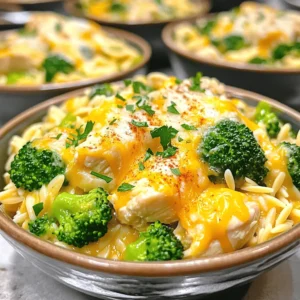 To make One Pot Cheesy Chicken and Broccoli Orzo, gather these simple ingredients: - 1 lb (450g) boneless, skinless chicken breasts, diced - 1 cup orzo pasta - 3 cups broccoli florets - 1 medium onion, diced - 3 cloves garlic, minced - 4 cups chicken broth - 1 cup shredded cheddar cheese - 1/2 cup grated Parmesan cheese - 2 tablespoons olive oil - Salt and pepper to taste - 1 teaspoon paprika - 1/2 teaspoon garlic powder - Fresh parsley, chopped for garnish These ingredients come together to create a creamy, cheesy dish that is both filling and nutritious. The chicken provides protein, while the broccoli adds vitamins. Using orzo pasta makes the dish comforting and satisfying. You can adjust the cheese levels based on your taste. For a fun twist, you can mix in extra spices or vegetables. You’ll find that this recipe is perfect for busy nights. It’s quick to prepare and cooks in just one pot, making cleanup a breeze. Plus, you can find the Full Recipe at the end of this article for detailed instructions. Enjoy making this delightful dish! Heat olive oil in a large pot over medium heat. Add diced chicken. Season it with salt, pepper, paprika, and garlic powder. Cook the chicken until it turns brown and is fully cooked, about 5-7 minutes. Once done, remove the chicken from the pot and set it aside. In the same pot, toss in the diced onion and minced garlic. Sauté for 2-3 minutes. You want the onion to turn translucent and fragrant. Now, stir in the orzo pasta and pour in the chicken broth. Bring this mixture to a boil. After it boils, reduce the heat to low. Let it simmer for about 10 minutes, stirring every so often. The orzo should be nearly cooked at this stage. Next, add the broccoli florets to the pot. Keep simmering for another 3-4 minutes. You want the broccoli to be tender and the orzo cooked al dente. Return the cooked chicken to the pot. Mix in the shredded cheddar cheese and grated Parmesan. Stir well until the cheeses melt and blend into a creamy mix. Adjust the seasoning if needed. Take the pot off the heat. Spoon the cheesy chicken and broccoli orzo into bowls. Garnish with fresh chopped parsley for a pop of color. For a nice touch, sprinkle some extra cheese on top and add a sprig of parsley. You can also add toasted breadcrumbs for a bit of crunch. For the full recipe, check [Full Recipe]. To enhance the flavor of your One Pot Cheesy Chicken and Broccoli Orzo, consider these seasoning tips: - Add a pinch of red pepper flakes for heat. - Use fresh herbs like thyme or basil for a bright taste. For a creamy texture, follow these cooking tips: - Stir the cheese in slowly for even melting. - Don't rush the simmering stage; let it meld together. Two common issues can ruin your dish: - Overcooking or undercooking the orzo can change its texture. Aim for al dente. - Using low-quality cheese can make the dish less flavorful. Always choose good cheese. Pair your cheesy chicken and broccoli orzo with these great sides: - A fresh garden salad adds a nice crunch. - Garlic bread complements the meal nicely. When serving, consider these options: - Serving from the pot keeps it casual and fun. - For a fancy touch, use individual bowls. {{image_2}} You can easily make One Pot Cheesy Chicken and Broccoli Orzo healthier. First, try substituting whole grain orzo for regular orzo. Whole grain orzo has more fiber, making it a better choice. Next, add more vegetables. You can include spinach, bell peppers, or carrots. This boosts nutrition and adds vibrant colors. To spice things up, add Italian seasoning or cayenne pepper. These spices give your dish a nice kick. If you want a different taste, try using different cheeses. Mozzarella or pepper jack can add a unique twist. Mixing cheeses can create new flavors that keep things interesting. If you're gluten-free, use gluten-free orzo. There are many brands available that taste great. For dairy-free diets, swap out the cheese for vegan cheese or nutritional yeast. You can also make a vegetarian version. Simply omit the chicken and add more veggies or beans for protein. These changes make the dish suitable for everyone. To keep your One Pot Cheesy Chicken and Broccoli Orzo fresh, store it in the fridge. Use an airtight container to avoid moisture loss. Make sure to cool the dish to room temperature before sealing it up. This keeps the flavors intact. Leftovers can last up to three days in the fridge. When you reheat the orzo, add a splash of chicken broth or milk. This keeps the dish creamy. You can use a microwave or stovetop. For the microwave, heat in short bursts. Stir in between to ensure even warming. If using the stovetop, heat on low, stirring slowly until it warms through. To freeze this dish, let it cool completely first. Pack it tightly in a freezer-safe container. Be sure to leave some space for expansion. This dish can stay good for up to three months in the freezer. When ready to eat, thaw it overnight in the fridge. Reheat as needed, following the same steps to keep it creamy. For the complete recipe, check out the [Full Recipe]. If you need a pasta swap, several options work well. You can use: - Ditalini pasta - Small shells - Couscous - Rice These choices will fit into the dish nicely. They all cook quickly and absorb flavor well. Yes, you can prepare this dish ahead of time. Here are some tips: - Cook the dish completely and cool it before storing. - Store it in an airtight container in the fridge. - You can also cook the chicken and veggies ahead, then add orzo later. This makes meal prep easy and fast. This dish lasts about 3 to 5 days in the fridge. To ensure safety: - Store it in a sealed container. - Always check for any signs of spoilage before eating. Yes, you can easily make it vegetarian. Here are some ideas: - Swap chicken for chickpeas or tofu. - Use vegetable broth instead of chicken broth. - Add extra veggies like bell peppers or mushrooms. These changes keep the dish tasty and filling. To reheat it, you have a couple of good options: - Use a microwave, heating in short bursts. Stir between each burst. - Heat on the stovetop over low heat. Add a splash of broth for moisture. These methods help keep the creamy texture intact. For the [Full Recipe], check out the main article. This recipe for One Pot Cheesy Chicken and Broccoli Orzo brings together simple steps and tasty ingredients. You learned how to sauté chicken, cook aromatics, and mix in cheeses for creamy goodness. Remember the tips for seasoning and avoid common mistakes to make it just right. You can also try variations to suit your needs. With the right storage and reheating methods, your leftovers will stay delicious. Enjoy this dish with family and friends, and let it brighten your meals!