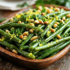 To make this dish sing with flavor, you need some key ingredients. Here’s what you need: - 1 pound fresh green beans, trimmed - 2 tablespoons olive oil - 1 lemon (zested and juiced) - 1/4 cup pine nuts - 2 cloves garlic, minced - Salt and pepper to taste - 1 tablespoon fresh parsley, chopped (for garnish) These fresh green beans are the star. They offer a crisp texture and vibrant color. The lemon adds zest and brightness. Olive oil helps bring all the flavors together. Garlic gives a rich, warm taste. Pine nuts add a delightful crunch. You can mix in some optional ingredients to enhance flavor. Consider adding: - Red pepper flakes for heat - A sprinkle of Parmesan cheese for richness - Toasted sesame seeds for an extra crunch These additions can take your dish to the next level. Just remember, keep it simple to let the green beans shine. You’ll need a few tools to make this recipe easy: - A large pot for boiling the beans - A slotted spoon for transferring the beans - A large skillet for sautéing - A dry pan for toasting the pine nuts - A cutting board and knife for chopping Having the right tools makes cooking smoother. It helps you focus on creating that fresh flavor boost. For the full recipe, check out the complete details. Enjoy the process! To start, we need to blanch the green beans. Boil a large pot of salted water. When it bubbles, add 1 pound of fresh green beans. Cook them for about 3 to 4 minutes. They should be bright green and tender-crisp. Next, use a slotted spoon to move them to an ice bath. This stops the cooking. Let the beans cool for a few minutes, then drain and set aside. Now, grab a large skillet and heat 2 tablespoons of olive oil over medium heat. Once the oil is hot, add 2 cloves of minced garlic. Sauté this for about 1 minute. You want it fragrant but not brown. Next, add the blanched green beans to the skillet. Toss them well in the garlic oil. Sauté for another 2 to 3 minutes until they heat through. Now it’s time for the burst of flavor! Sprinkle the lemon zest from 1 lemon over the green beans. Squeeze in the fresh lemon juice next. Don’t forget to season with salt and pepper to taste. Toss everything together to combine all the flavors. You’ll notice how fresh and vibrant this dish starts to smell! In a separate dry pan, toast 1/4 cup of pine nuts over medium heat. Stir them often for about 3 to 4 minutes. Keep a close eye on them. You want them golden brown and fragrant, not burnt. Once done, remove the pan from heat. Now, you can put your dish together! Serve the green beans topped with those delicious toasted pine nuts. For a final touch, sprinkle some chopped parsley for color. Enjoy this fresh flavor boost! You can find the full recipe above. To cook green beans just right, start with a pot of salted water. Bring it to a rolling boil. Add the green beans and cook for 3 to 4 minutes. You want them bright green and tender-crisp. This short cook time keeps them fresh and crunchy. After cooking, quickly place them in an ice bath. This stops the cooking and locks in their color. Drain them well before using. To boost the taste, use fresh ingredients. Fresh lemon juice and zest brighten the dish. Garlic adds depth and warmth. When cooking, make sure to sauté the garlic until fragrant but not burnt. Toasting the pine nuts brings out their nutty flavor. This extra step makes a big difference. Don't forget to season with salt and pepper. This helps balance the flavors and makes them pop. A well-plated dish makes a meal more inviting. After cooking, arrange green beans neatly on a plate. Sprinkle the toasted pine nuts on top for a nice crunch. Add a touch of chopped parsley for color. This adds a fresh look and a hint of flavor. Serve with lemon wedges on the side. This gives guests the option to add more lemon if they like. For the full recipe, check out the section above. {{image_2}} If you cannot find pine nuts, try using chopped walnuts or almonds. Both nuts add a nice crunch. Sunflower seeds also work well for a nut-free option. They provide a similar texture without using nuts. For a cheesy twist, sprinkle some grated Parmesan or feta cheese on top. The saltiness of the cheese pairs well with the lemon. You can also add spices like red pepper flakes for heat or smoked paprika for depth. Fresh herbs such as basil or thyme can enhance the dish too. You can cook these green beans in different ways. Steaming keeps the beans crisp and bright. Simply place them in a steamer over boiling water for about 5-7 minutes. Roasting adds a nice char and extra flavor. Toss the beans with olive oil and roast at 400°F for 15-20 minutes. Each method offers a unique taste experience. For the full recipe, check out the detailed instructions above. To keep your green beans with lemon and pine nuts fresh, store them in an airtight container. This helps maintain their crispness and flavor. Place the container in the fridge. They can stay good for up to 3 days. If you notice any limpness, try refreshing them in a quick ice bath before serving again. When it's time to reheat, use a skillet. Heat a little olive oil over medium heat. Add your green beans and stir gently until they are warm. This method keeps them tender-crisp. You can also microwave them, but cover them with a damp paper towel. Heat in short bursts to avoid overcooking. If you want to freeze your green beans, do this right after cooking. Let them cool completely. Then, place them in freezer-safe bags or containers. Remove as much air as possible to prevent freezer burn. When you are ready to eat, thaw them in the fridge overnight. Reheat them in a skillet for the best texture. For the full recipe, check out the details above. Yes, you can use frozen green beans. They cook faster than fresh beans. Just follow the same cooking steps. Frozen beans may not be as crunchy, but they still taste good. To make this recipe vegan, simply use olive oil and skip any animal products. The lemon and pine nuts add great flavor without dairy. You can enjoy all the freshness without changing the taste. You can serve these green beans with grilled chicken, fish, or quinoa. They pair well with salads or roasted vegetables too. This dish adds color and flavor to any meal. Cooked green beans last about 3 to 5 days in the fridge. Store them in an airtight container to keep them fresh. Make sure they cool down before sealing. You can find the full recipe for Green Beans with Lemon and Pine Nuts in the section above. It includes all the ingredients and steps needed to make this delicious dish. This post covered how to make green beans with lemon and pine nuts. We discussed key ingredients, step-by-step cooking instructions, and helpful tips. You learned about storage methods, variations, and common questions. With these insights, you can create a tasty dish that impresses. Green beans can be simple but delicious with the right touches. Enjoy making this dish your own!