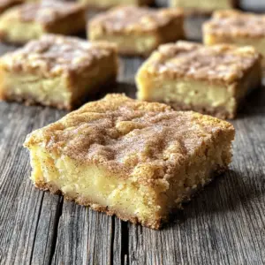 - 1 cup unsalted butter - 2 cups brown sugar - 2 large eggs - 1 teaspoon vanilla extract - 2 cups all-purpose flour For these chewy snickerdoodle blondies, we need some key ingredients. First, we use unsalted butter. It gives a rich flavor and smooth texture. The brown sugar adds moisture and a deep taste. Large eggs help bind everything together. A touch of vanilla extract brings warmth and sweetness. Finally, all-purpose flour gives structure to our blondies. - 1 teaspoon baking powder - 1 teaspoon cream of tartar - 1/2 teaspoon salt Next, we mix in our dry ingredients. Baking powder makes the blondies rise and stay soft. Cream of tartar adds a slight tang and helps with texture. A bit of salt balances the sweetness and enhances flavor. - 1/4 cup granulated sugar - 2 teaspoons ground cinnamon For the topping, we combine granulated sugar and ground cinnamon. This mix gives a lovely sweet and spicy kick. When baked, it forms a delightful crust on top of the blondies. Each bite is a wonderful blend of flavors. - Preheat your oven to 350°F (175°C). - Line a 9x13 inch baking pan with parchment paper. Leave some overhang for easy removal. - In a large bowl, whisk together the melted butter and brown sugar. Mix until the blend is smooth. - Add the eggs one at a time. Mix well after adding each egg. Stir in the vanilla extract until mixed. - In another bowl, combine the flour, baking powder, cream of tartar, and salt. Whisk them together. - Gradually fold the dry mix into the wet mix. Use a spatula and mix until just combined. Some lumps are okay. - Pour the blondie batter into the prepared pan. Spread it evenly across the pan. - In a small bowl, mix the granulated sugar and ground cinnamon for the topping. Sprinkle it evenly over the batter. - Bake in the preheated oven for 20-25 minutes. Test with a toothpick; it should come out with a few moist crumbs. To get that perfect chewy texture, first, do not overmix the batter. When you mix, stop as soon as the dry and wet ingredients blend. A few lumps are perfectly fine. Second, pay close attention to baking time. Bake for 20-25 minutes. You want a toothpick to come out with some moist crumbs, not wet batter. To boost flavor, I suggest using pure vanilla extract. It gives a rich taste. You can also add a pinch of nutmeg to the batter. This little twist adds warmth and depth to the blondies. For best results, use quality ingredients. Fresh brown sugar and unsalted butter work wonders. You will also need a few tools: a large mixing bowl, a whisk, and a spatula. A 9x13 inch baking pan lined with parchment paper makes for easy removal. These tools and ingredients can elevate your baking game! {{image_2}} You can easily change the flavor of these blondies. Adding chocolate chips gives a rich taste. Try mixing in a cup of semi-sweet chocolate chips before baking. You can also add nuts like walnuts or pecans for some crunch. Another fun twist is to use pumpkin spice. This spice mix adds warmth and a seasonal flair. Just swap out some cinnamon for pumpkin spice. It’s perfect for fall! If you need gluten-free options, you can use gluten-free flour. This swap keeps the texture light and chewy. For those who prefer vegan recipes, you can replace eggs with flax eggs. Mix one tablespoon of flaxseed meal with three tablespoons of water. Let it sit for a few minutes until it thickens. This works well in the recipe and keeps it delicious. Serve your blondies warm with a scoop of ice cream. Vanilla or cinnamon ice cream pairs well. You can also top them with whipped cream for extra creaminess. For a healthier option, try adding fresh fruit or a berry sauce. If you want gluten-free or dairy-free toppings, use coconut whipped cream or dairy-free ice cream. These options let everyone enjoy this tasty dessert! To keep your Chewy Snickerdoodle Blondies fresh, store them in an airtight container. This step helps lock in moisture and flavor. Place a piece of parchment paper between layers if you stack them. You can store these blondies at room temperature for up to four days. If you want to keep them longer, consider freezing them. To freeze your blondies, first let them cool completely. Then, wrap each square tightly in plastic wrap. Place the wrapped blondies in a freezer-safe bag or container. They will stay fresh for about three months in the freezer. When you're ready to enjoy them, thaw them in the fridge overnight or at room temperature for a few hours. For the best taste, reheat your blondies in the oven. Preheat your oven to 350°F (175°C). Place the blondies on a baking sheet and heat for about 5-10 minutes. This method keeps them chewy and soft. You can also use the microwave for a quick option. Heat them in 10-second bursts until warm, but be careful not to overheat them. Yes, you can use margarine instead of butter. However, the taste and texture may change. Butter gives a richer flavor. If you use margarine, choose a stick form for best results. To check if your blondies are done, insert a toothpick in the center. If it comes out with a few moist crumbs, they're ready. Do not wait for it to come out clean. Overbaking will make them dry. Absolutely! You can make the blondies a day in advance. After baking, let them cool and store them in an airtight container. They stay fresh and tasty for up to three days. Blondies and brownies are both tasty treats but differ in flavor and texture. Brownies contain cocoa powder, which gives them a chocolate flavor. Blondies, on the other hand, have a rich, buttery taste with hints of vanilla and cinnamon. You now know how to make delicious blondies with simple steps and ingredients. Remember to follow the mixing and baking tips for a chewy texture. Feel free to explore flavor variations, from adding chocolate chips to using seasonal spices. Proper storage will keep them fresh, so you enjoy them longer. These blondies can brighten any gathering or snack time. Embrace your creativity and make this recipe your own. With these tips, you are ready to bake the best blondies!